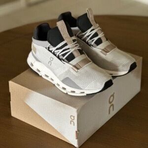On Running Cream and Black Athletic Shoes